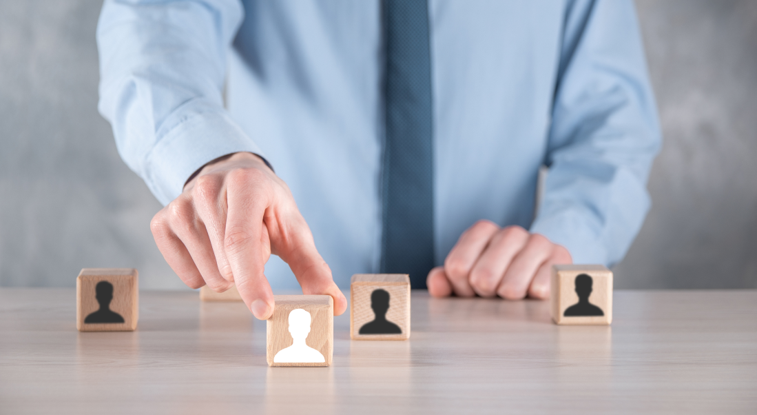 Person selecting wooden blocks with user icons